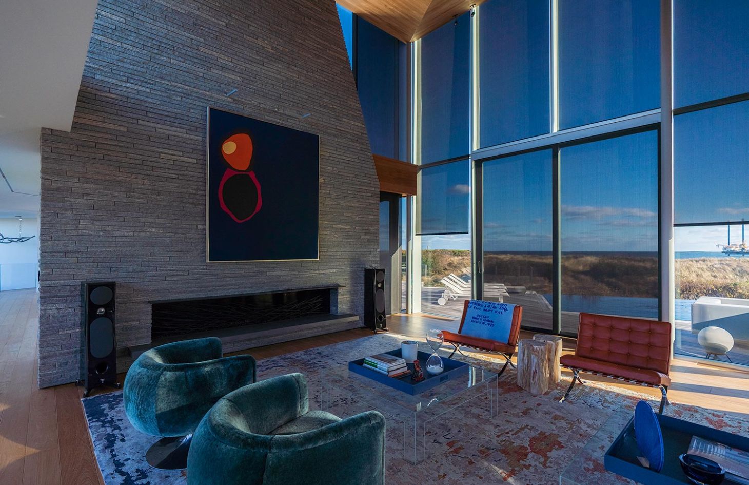 Living Room with modern artwork in stone wall closed shades protecting from sunshine